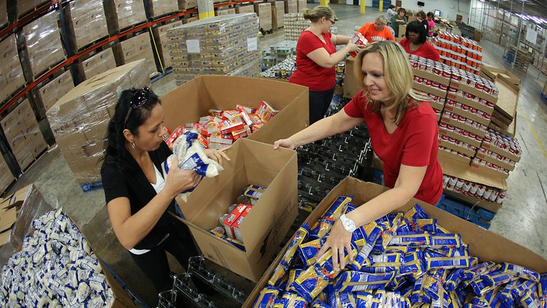 Volunteers fill boxes with nonperishables food items at the Feed the Children distribution center in Oklahoma City, Oklahoma, USA, 22 May 2013. The boxes will be given to various non-profits to help the Moore, Oklahoma tornado victims. The town was hit by a tornado on 20 May killing at least 24 people including seven children in one school. 