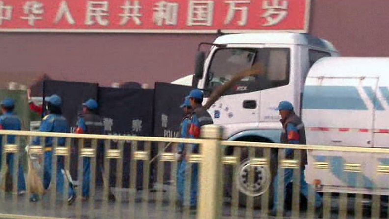 Siivoojia luutineen komennettiin Tiananmenin aukiolle korjaamaan autopalon jälkiä. 