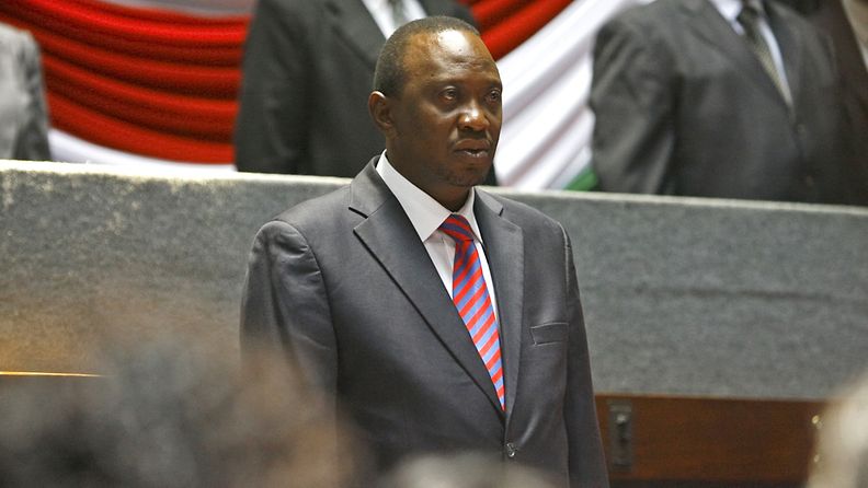 Kenya's President-elect Uhuru Kenyatta stands for a national anthem prior to a meeting with women leaders of his Jubilee coaliton in Nairobi, Kenya, 14 March 2013. Duing a meeting, Kenyatta said the country has no time to waste as Kenyans have to move on, referring to a move by his main rival and a defeated candidate Raila Odinga to challenge the election result in court.