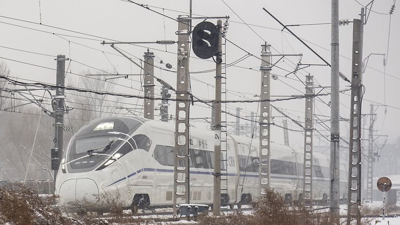 A high speed train undergoes testing in snowy conditions, covered with sensors taped to its front, at the national railway technology center in the suburbs of Beijing, China, 14 December 2012. Beijing has had three days with snow coming just one week after what local media reported as the coldest week in 14 years.