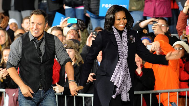 Rock Legend Bruce Springsteen, walks with First Lady Michelle Obama after performing at a huge campaign rally for Democratic candidate for United States President, Barack Obama in Des Moines, Iowa, USA, 05 November 2012. After nearly 18 months of campaigning and after an estimated billion dollars spent, United States President Barack Obama faces Republican candidate for United States President Mitt Romney in the national election on 06 November 2012.
