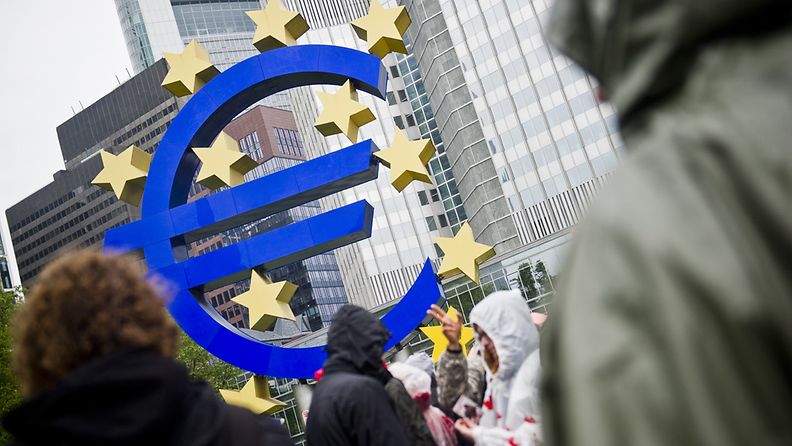 Activists of the Blockupy movement stand outside the European Central Bank (ECB) during a protest in central Frankfurt, Germany, 31 May 2013. At least 1,000 people took part in an anti-austerity protest at the European Central Bank (ECB) building. 