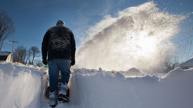 After the storm passed, Tyler Bowden clears the sidewalk with a snowblower in Greenfield, Massachusetts, USA, 09 February 2013. A massive winter storm dumped two feet of snow on the area and throughout the northeast US with possibly more to come today. EPA/MATTHEW CAVANAUGH                     