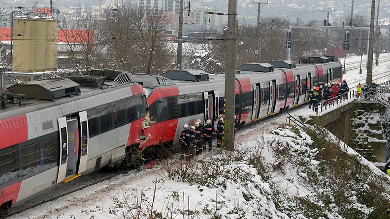 Firefighters and emergency medical services work at the scene of a train collision in Vienna, Austria, 21 January 2013. According to media reports, several people were injured when two regional trains collided on the morning of 21 January. EPA/ROLAND SCHLAGER 