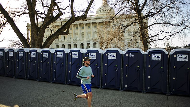 A early morning jogger runs past the portable restrooms surrounding the United States Capitol in Washington, DC, USA, 20 January 2013. The public ceremony for the swearing in of US President Barack Obama for his second term in office will take place on the West Front of the Capitol Building on 21 January. EPA/PETE MAROVICH                     