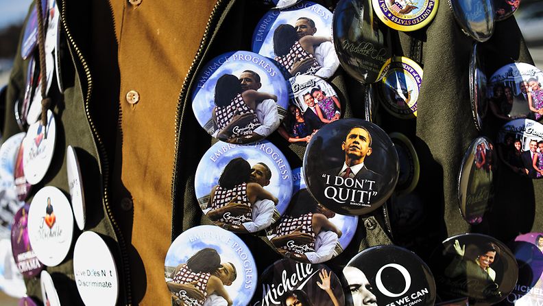 A street vendor selling inauguration memorabilia is covered in Obama buttons in Washington, DC, USA, 20 January 2013. Street vendors are out in full force on the day before the public ceremony for the swearing-in of US President Barack Obama for his second term in office. EPA/PETE MAROVICH                     