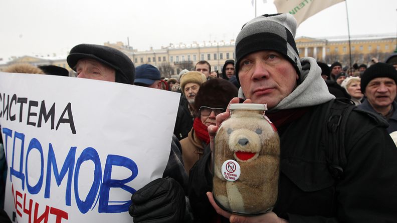 People take part in a rally, with a toy seen inside a glass jar, to protest against the law, passed in late December 2012, that bans US citizens from adopting Russian children at the Marsovo Pole in St. Petersburg, Russia, 13 January 2013. Reports state that thousands of demonstrators gathered for a march in Moscow and St. Petersburg to protest against a ban on US citizens adopting Russian children, saying President Vladimir Putin's government had made orphans pawns in a political dispute. EPA/ANATOLY MALTSEV                     