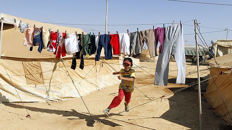 A Syrian child, who fled with family the violence in his country, plays at Al-Zaatri Syrian refugee camp, at the north east city of Mafraq, Jordan, 13 September 2012. The United Nations says an estimated 1.2 million Syrians, more than half of them children, are internally displaced. Additionally, about 250,000 refugees have sought shelter in neighbouring Jordan, Lebanon, Turkey and Iraq. EPA/JAMAL NASRALLAH 