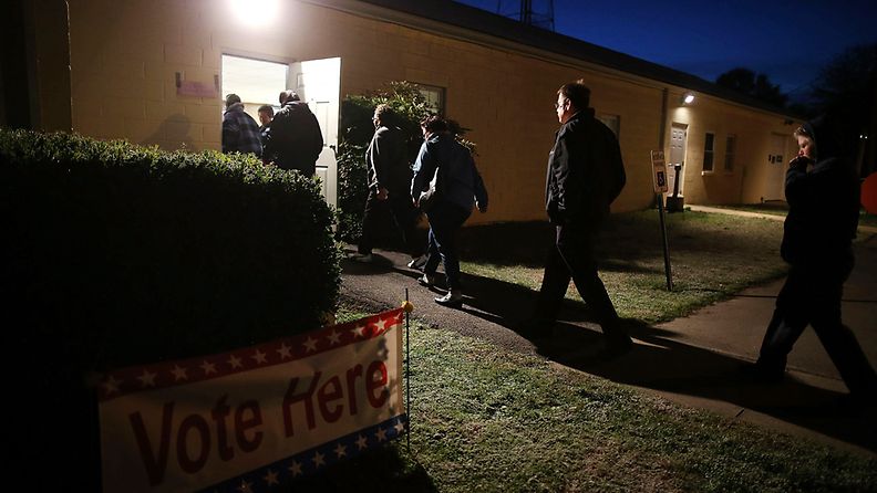 PORT ROYAL, VA - NOVEMBER 06: People enter the Port Royal Fire House to cast their vote in the U.S. presidential race, , on November 6, 2012 in Port Royal Virginia. Recent polls show that U.S. President Barack Obama and Republican presidential candidate Mitt Romney are in a tight race.