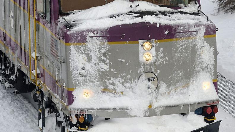 A Massachusetts Bay Transportation Authority Snow Train equipped with a snow plow clears snow from the tracks as light snow continues to fall following more than two feet (60 cm) of snowfall in Norfolk, Massachusetts, USA, 09 February 2013. 