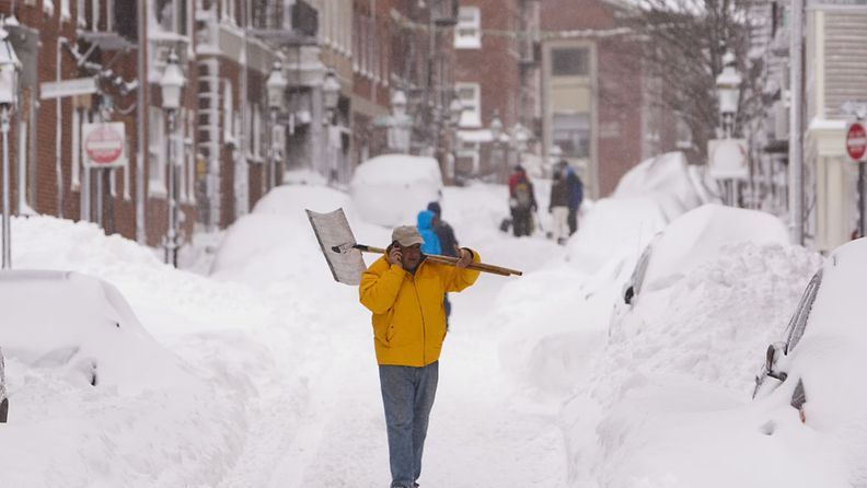 A man takes a phone call break from shovelling on Battery Street in the North End as Bostonians dig out from under winter storm Nemo in Boston, Massachusetts, USA, 09 February 2013.