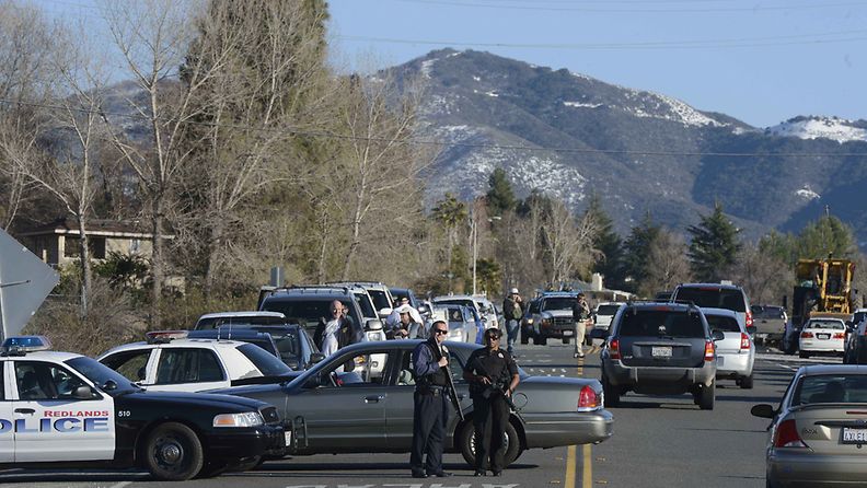 Police man a road block near Highway 38 into the Big Bear area where a shoot-out with suspected fugitive Christopher Dorner resulted in the death of a San Bernardino Sheriff deputy in Yucaipa, California, USA, 12 February 2013. Dorner is suspected in the killing of a police captain's daughter, her fiancee, and a Riverside Police Department Officer. A massive manhunt for Dorner is underway in southern California. EPA/MICHAEL NELSON 