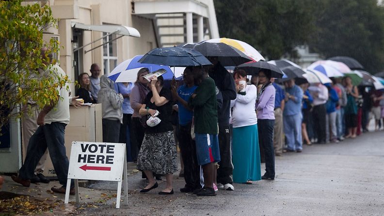 ST. PETERSBURG, FL - NOVEMBER 6: Lines of voters wait in the rain to cast their vote on November 6, 2012 in St. Petersburg, Florida. The swing state of Florida is recognised to be a hotly contested battleground that offers 29 electoral votes, as recent polls predict that the race between U.S. President Barack Obama and Republican presidential candidate Mitt Romney remains tight.