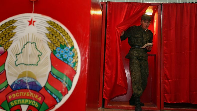 A Belarussian soldier leaves a voting booth with his ballot paper at a polling station during the parliamentary elections in Minsk, Belarus, 23 September 2012. Voters in the former Soviet republic of Belarus began electing a new parliament. EPA/TATYANA ZENKOVICH 