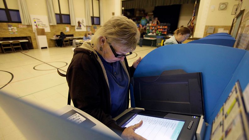 BOWLING GREEN, OH - NOVEMBER 6: A woman casts her ballot using an electronic voting machine at an elementary school on November 6, 2012 in Bowling Green, Ohio. Voting is underway in the US presidential election in the battleground state of Ohio. Recent polls show that U.S. President Barack Obama and Republican presidential candidate Mitt Romney are in a tight race.