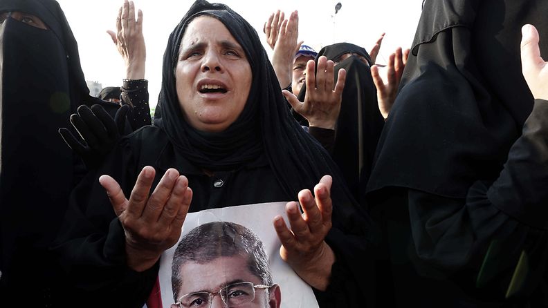  Egyptian women supporters of ousted President Mohammed Morsi pray for those killed in clashes one day earlier, as they protest near the Rabaa Adawiya mosque in Cairo, Egypt, 09 July 2013.