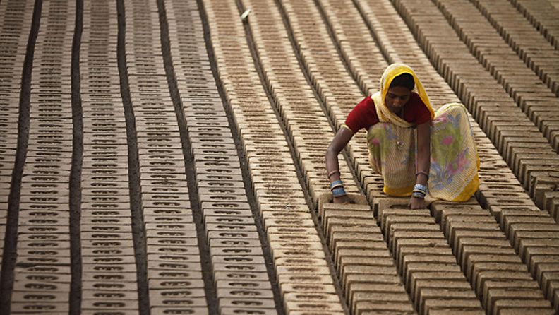  An Indian woman works at a brick factory on the outskirts of Jammu, India,Thursday March 8, 2012. International Women's Day is being marked Thursday. (AP Photo/Channi Anand)  