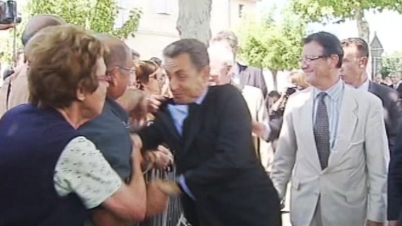 Sarkozya riepotellut käsi ilmestyi kuin tyhjästä. 