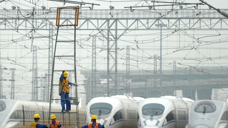 A picture made available on 17 June 2011 shows workers labor outside the maintenance center for CRH trains of the Beijing-Shanghai High-Speed Railway in Shanghai, China, on 16 June 2011. 