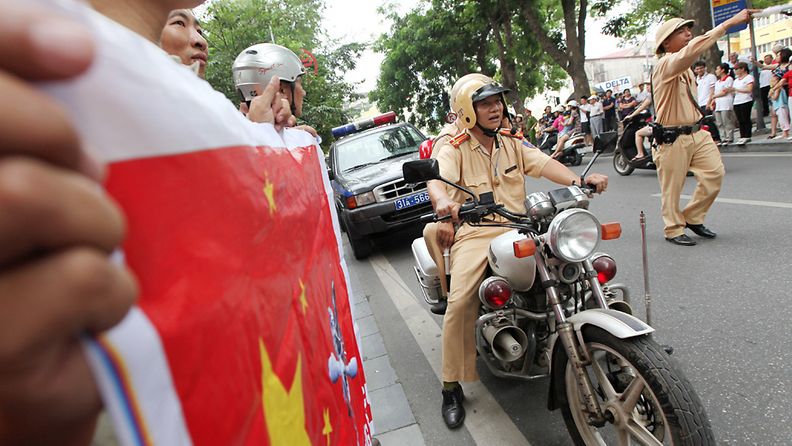 Police move against people on the street during a protest demanding China to stay out of Vietnamese waters following China's increased activities around the Spratly Islands and other disputed areas, in Hanoi, Vietnam, 07 August 2011. According to reports about 500 hundred anti-China protesters marched around Hoan Kiem lake today in the 9th week of anti China protests. 
