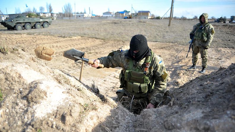 Ukrainalaissotilas kaivoi juoksuhautaa