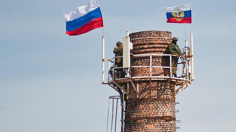 Aseistautuneet miehet nostivat Venäjän lipun Ukrainan laivaston tukikohtaan Sevastopolissa Krimillä 19.3.2014.