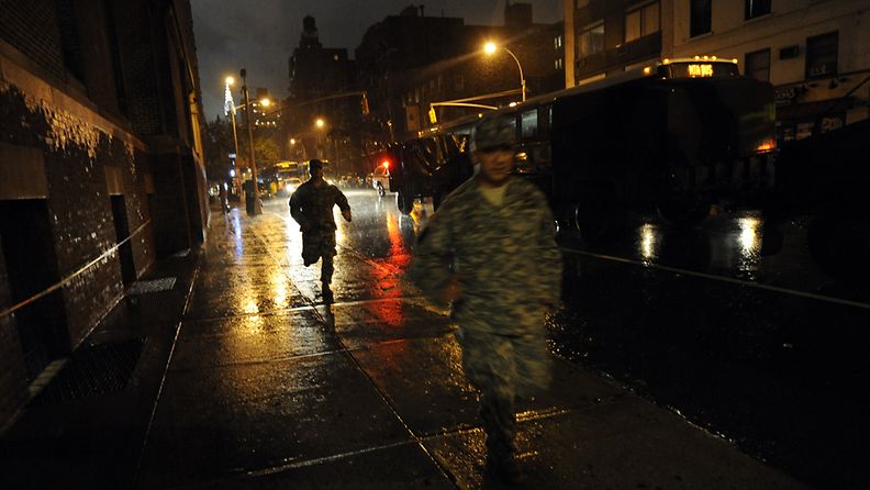 New York National Guard officers run towards the Sixty-Ninth Regiment Armory where they are staying ahead of Hurricane Irene in New York, New York, USA, 27 August 2011. The New York area is bracing for Hurricane Irene to hit late on August 27 and into August 28.