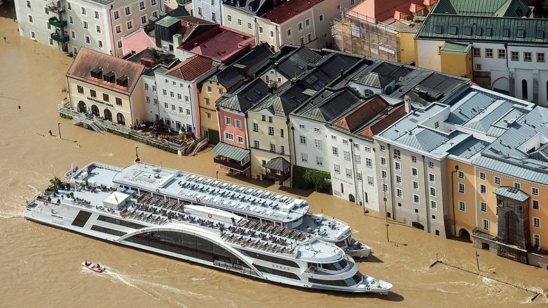 Passenger ships in front of the partially flooded old town of Passau, Germany, 05 June 2013, which were flooded by the Danube. Large parts of Central Europe and Germany remained on flood alert on 05 June, with mass evacuations continuing as flood crests reached more towns and the death toll rose to 15. 