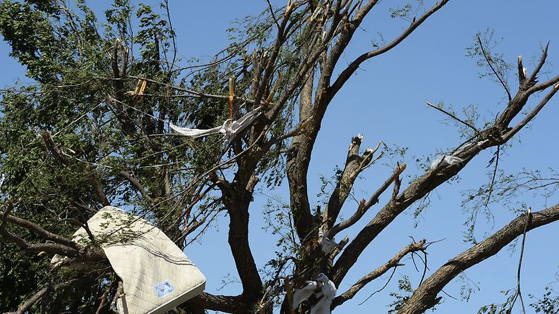 A bed matress hangs in a tree near a house in El Reno, Oklahoma, USA, 01 June 2013. At least nine people died in the central US state of Oklahoma after tornadoes struck an area already devastated by twisters less than two weeks ago, media reported on 01 June. 