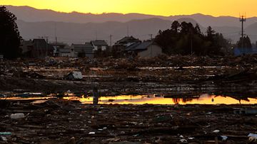 Aurinko laskee tuhoutuneen maiseman yllä Fukushiman maakunnassa. Kuva: EPA