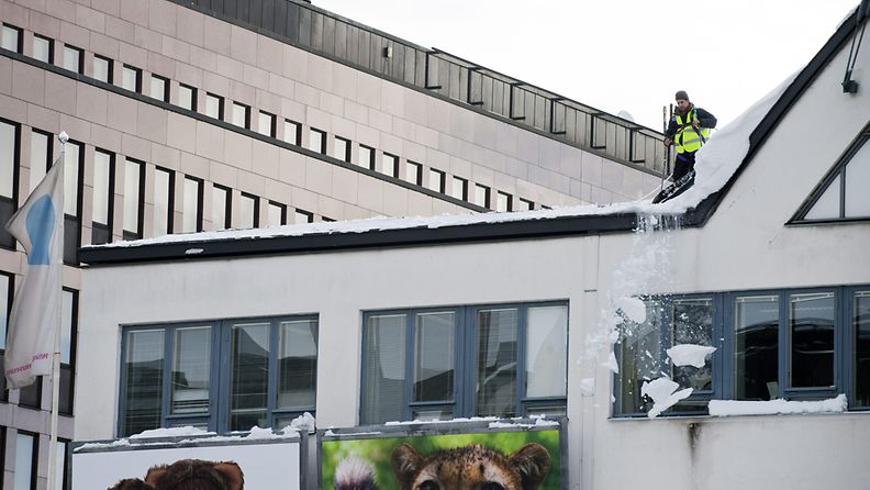 Lumenpudottaja tekee työtään Lasipalatsin katolla Helsingissä 20. helmikuuta 2012.