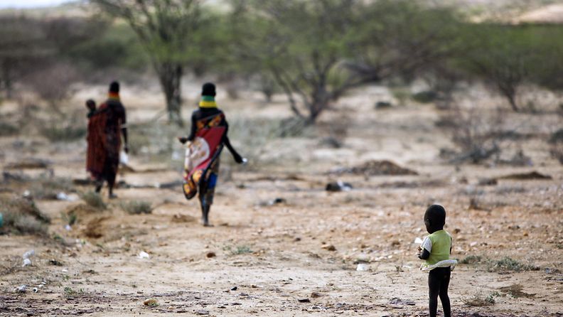 An ethnic Turkana boy stops briefly as he follows his mother after receiving a medical treatment in Makutano, near Kakuma refugee camp, Turkana District, northwestern Kenya, 08 August 2011.