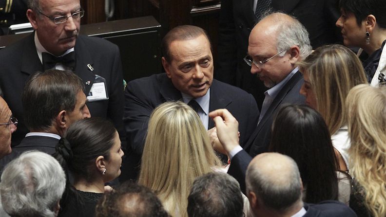Italian Prime Minister, Silvio Berlusconi (C), talks in the Chamber of Deputies in Rome, Italy 15 July 2011 after Italy's lower house of parliament voted in favour of a motion of confidence in the government.