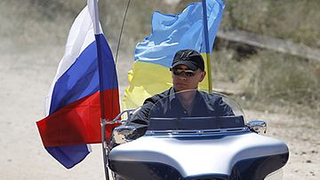 Venäjän pääministeri Vladimir Putin kasvatti machomiehen mainettaan Ukrainassa 24.7.2010, kun hän hyppäsi Harley Davidsonin selkään. (Kuva: EPA)