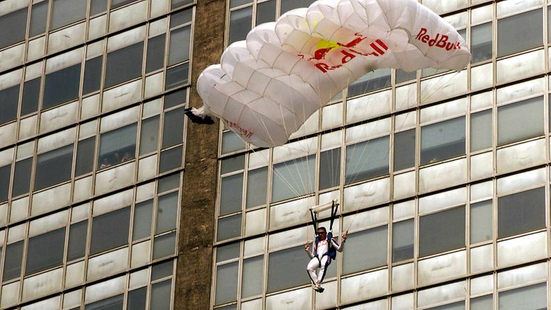 Austrian parachutist Felix Baumgartner plummets down as his chute opens after jumping from the top of the 137 metre high Pirelli skyscraper in the centre of Milan, Friday 30 July 1999.