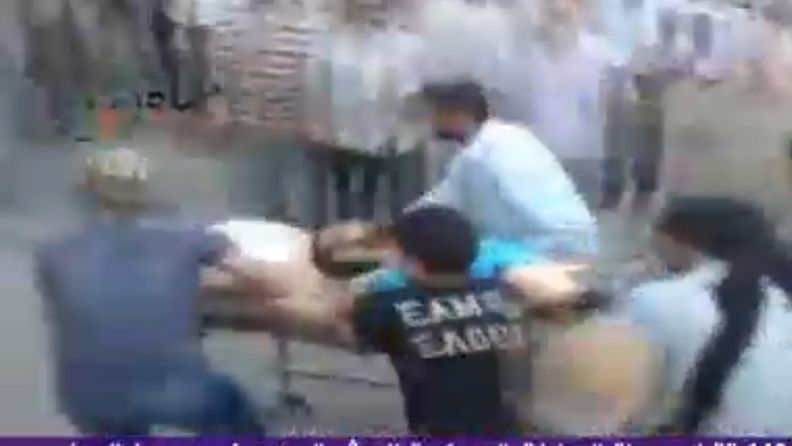 A TV grab taken from Al Arabiya channel on 01 August 2011 shows Syrian protesters carrying an injured man following attacks by the Syrian army on the city of Hama, Syria.