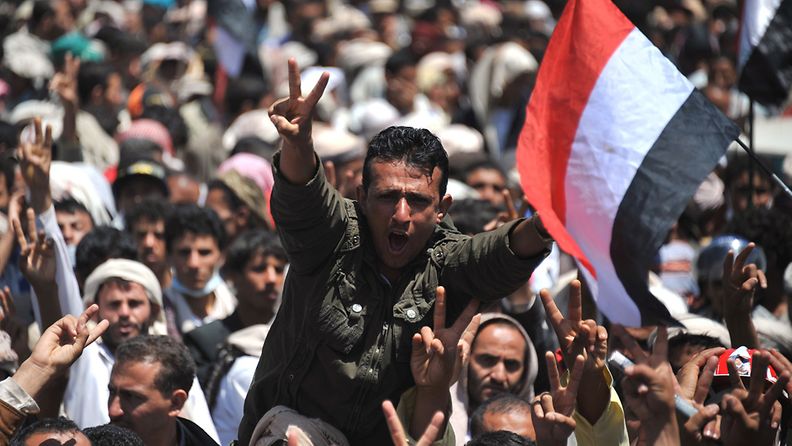 Yemeni protesters shout slogans and wave Yemeni flags during a protest against the 33-year rule of Yemeni President Ali Abdullah Saleh in Sana'a, Yemen, 20 September 2011.