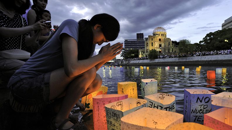 A woman prays after floating a paper lantern on the Motoyasu River to honour the victims of the world's first atomic bombing in Hiroshima, Japan, 06 August 2011, to mark the 66th anniversary of the 1945 atomic bombing.