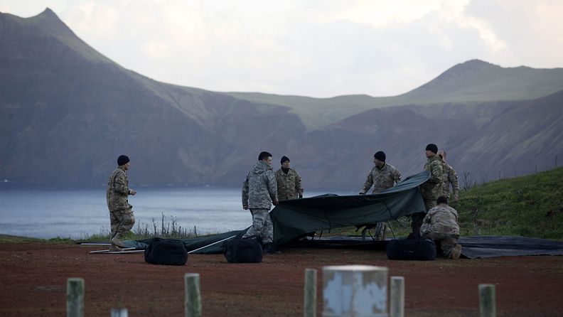 Members of Chilean Air Force build a tent during the search works the day after a military aircraft crashed in the Juan Fernandez archipelago, 670 kilometers from chilean coasts, on 03 September 2011.