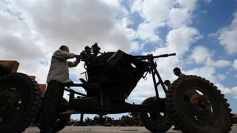 A picture made available the 16 of August 2011 shows a man belonging to the rebel fighters, preparing an anti-aircraft machine gun, at a rebel military base in Benghazi, Libya, 13 August 2011.
