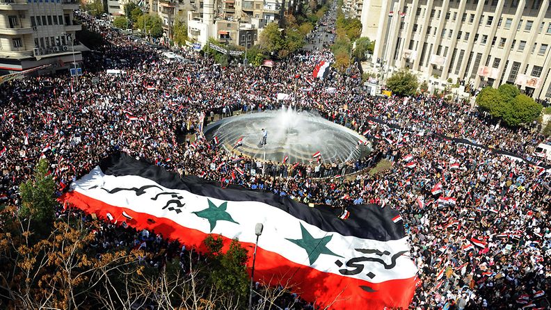 A handout picture released by Syrian news agency SANA shows tens of thousands of Syrians flocked in Sabe Bahrat square in downtown Damascus, Syria on 13 November 2011 to express anger over the Arab League's decision taken 12 November to suspend Syrias membership citing Syria's alleged failure to end a deadly crackdown on civilian protests. 