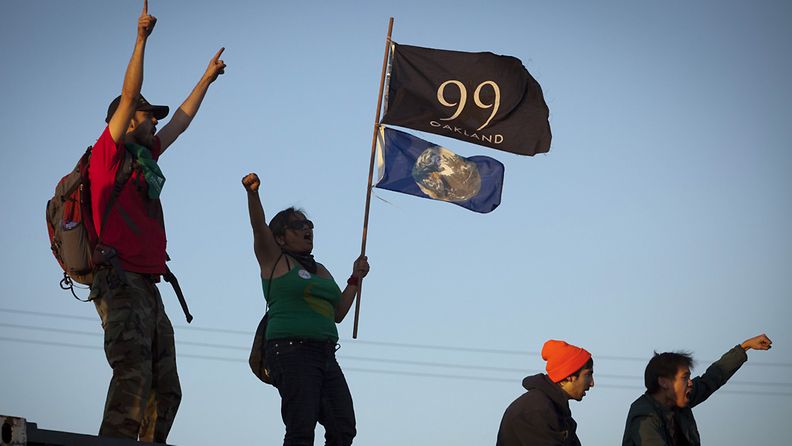 Supporters of the Occupy Oakland movement stood atop shipping containers after shutting down the Port of Oakland during a general strike that also shut down the city of Oakland, California, USA, 02 November 2011.