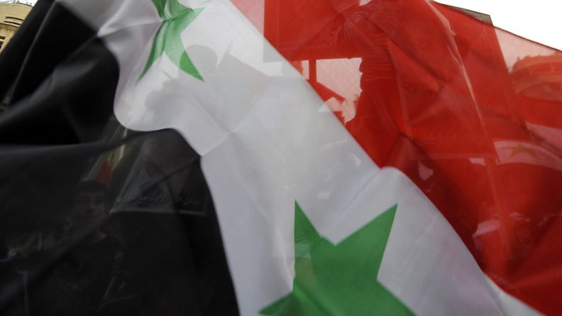 Lebanese and Syrians living in Lebanon carry Syrian flags during a demonstration in support of the Syrian regime in downtown Beirut, Lebanon, 22 February 2012. At least 51 people, including two Western journalists, were killed on 22 February by government troops across Syria, the opposition Syrian Local Coordination Committee (LCC) reported. Most of the deaths occurred in the province of Homs, while others were killed in the provinces of Idlib and Hama, according to the LCC. EPA/WAEL HAMZEH