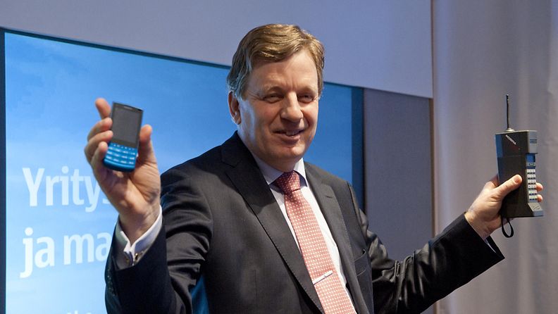 Nokian yhteiskuntasuhteista vastaava johtaja Esko Aho (kädessään Nokian älypuhelin X3 ja 20 vuotta vanhempi Mobira Cityman 1320) kertoo lehdistötilaisuudessa matkapuhelimien valmistuksen eeettisyydestä ja ympäristönäkohdista yrityksen pääkonttorissa Espoossa 21. tammikuuta 2011. 