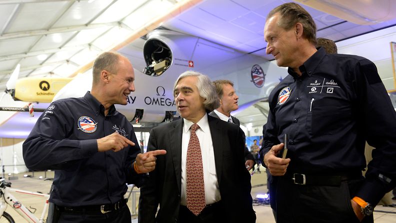 Co-founders and pilots of Solar Impulse, a long-range solar powered aircraft, Bertrand Picard (L) and Andre Borschberg (R) chat with US Secretary of Energy Ernest Moniz (C)