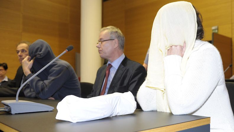 8-vuotiaan Vilja Eerikan murhasta syytettynä oleva 35 -vuotias isä (vas. huppu päässä) ja naisystävä (oik. valkoisessa takissa) Helsingin käräjäoikeudessa 5. maaliskuuta 2013.