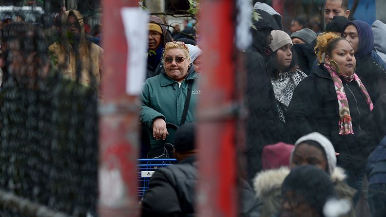 People wait in line to receive food and supplies at a food distribution site to help those in areas without power as the city tries to recover from the after effects of Hurricane Sandy in the East Village of New York, New York, USA, 01 November 2012.