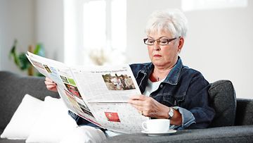 vanhempi nainen lukee lehteä