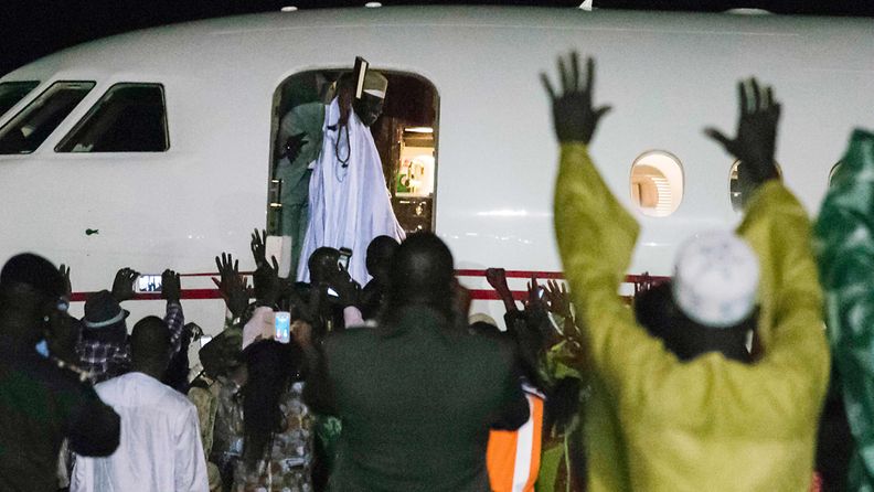 Former president Yaya Jammeh (C,up), the Gambia's leader for 22 years, waves from the plane as he leaves the country on 21 January 2017 in Banjul. 
