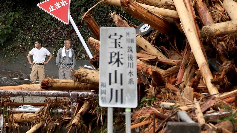 Paikallisia asukkaita katsomassa tulvan aiheuttamia tuhoja Japanissa.